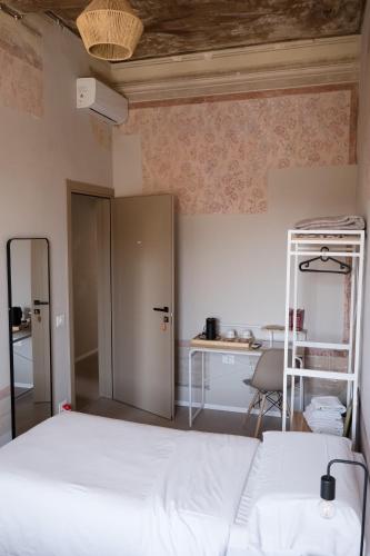 a bedroom with a bed and a desk and a ladder at Aretium in Arezzo