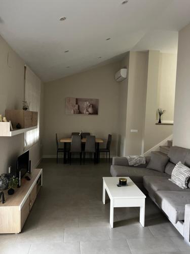 a living room with a couch and a table at La terraza de la subbética in Luque