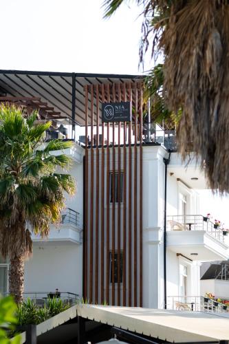 a building with a red and white stripes at Nia Boutique Hotel by Rapo's Resort in Himare