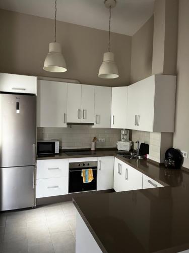 a kitchen with white cabinets and a black counter top at La terraza de la subbética in Luque