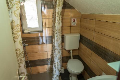 a small bathroom with a toilet and a window at Etno Gostilnica Villa Fulko in Ohrid