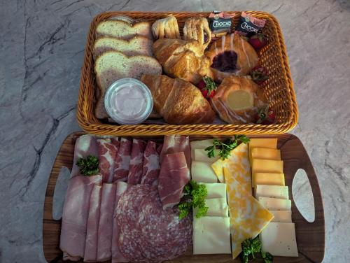 two baskets filled with different types of bread and pastries at Suite in the Bush-Private Apartment in Bancroft