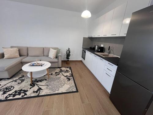 a living room with a couch and a table in a kitchen at Fred apartment in Nea Fokea