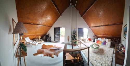 a living room with a couch and a christmas tree at Demetrio House in Santo Antônio do Pinhal