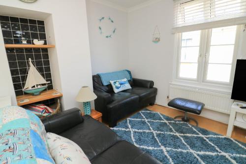 a living room with a couch and a chair at The Hideaway in Dartmouth