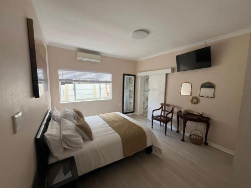Ένα ή περισσότερα κρεβάτια σε δωμάτιο στο La Vida guest house