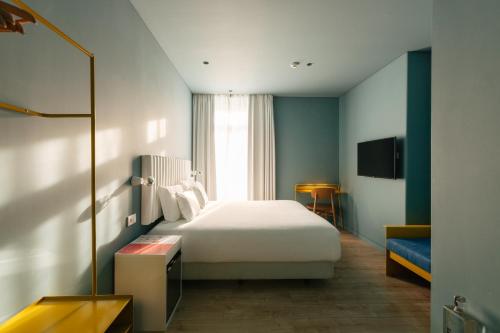 a hotel room with a bed and a window at Esqina Cosmopolitan Lodge in Lisbon