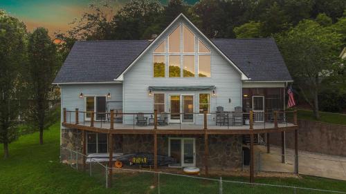a house with a wrap around porch and a deck at Family Friendly Lakefront with Private Dock Fire Pit Near Marinas in La Follette