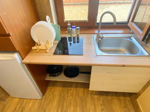 a kitchen with a sink and a counter top at Hotel Orange Kutaisi in Kutaisi