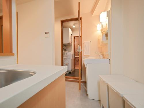 a kitchen with white countertops and a sink and a sink at Kiryo Tokyo Kami Itabashi 2 Bedroom Apartment with Kitchen near Ikebukuro in Tokyo