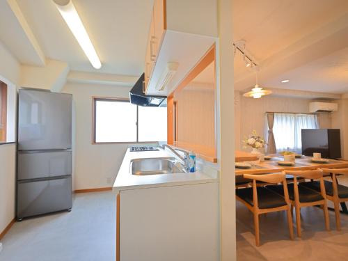 a kitchen and dining room with a table and a refrigerator at Kiryo Tokyo Kami Itabashi 2 Bedroom Apartment with Kitchen near Ikebukuro in Tokyo