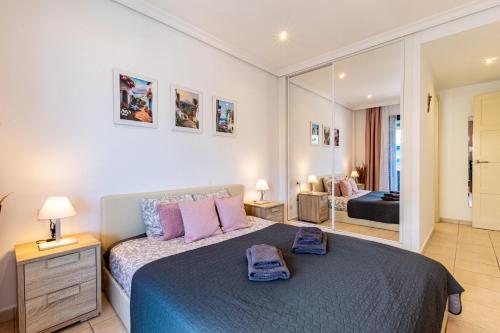 a bedroom with a large bed and a mirror at Top Floor Ocean View Apt By Dream Homes Tenerife in Puerto de Santiago