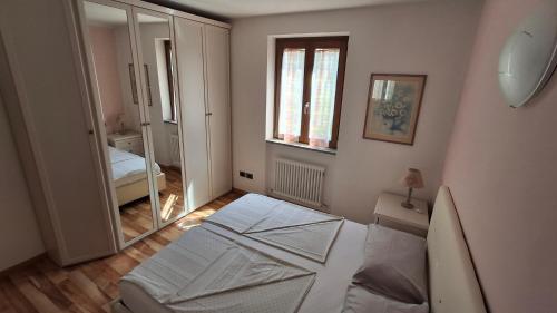 a small room with a bed and a mirror at La Bella Corte in Arco