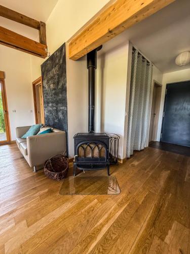 a living room with a fireplace and a couch at Gîte Domaine Taureau in Saint-Brisson