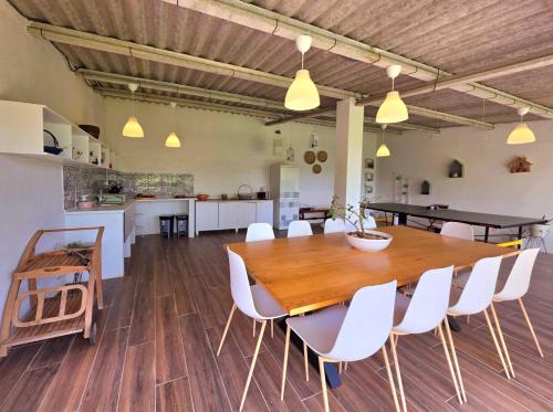 a kitchen and dining room with a wooden table and chairs at Casa do Avô Manuel in Valença