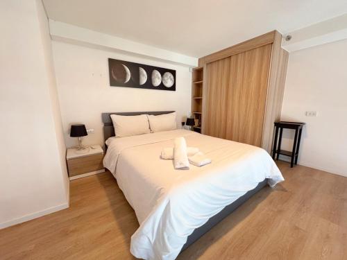 a bedroom with a bed with two towels on it at BTS onnut loft quiet room Netflix Rooftop bar in Bangkok