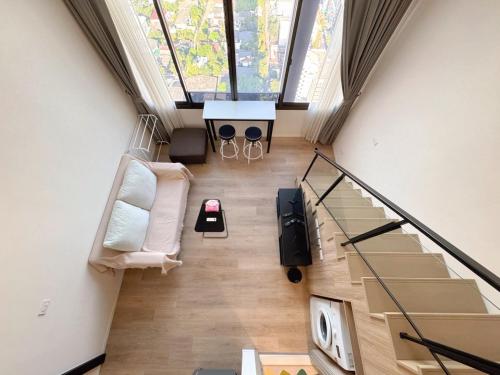 an overhead view of a living room with a staircase at BTS onnut loft quiet room Netflix Rooftop bar in Bangkok