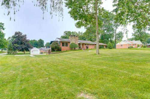 a large yard with a house and a tree at 3 Mi to Pro Football Hall of Fame Home with Yard! in Canton