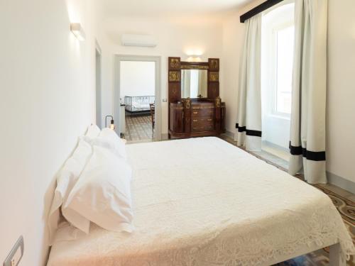 a bedroom with a large bed and a window at Dimora Storica Palazzo Didonna in Rutigliano