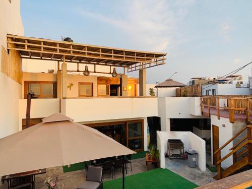 an umbrella sitting on top of a building at El Templo Surf House in Punta Hermosa