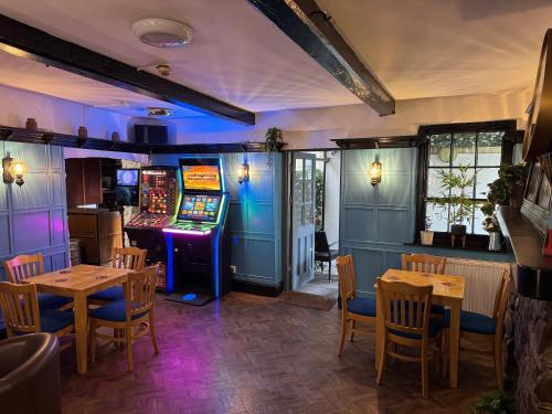 a dining room with tables and a slot machine at The Drovers Arms Hotel in Carmarthen
