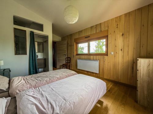 a bedroom with a white bed and a window at Gîte Domaine Taureau in Saint-Brisson
