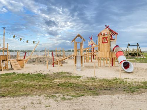 a playground on the beach with a slide at Villa Maroma Mistral Veerse Meer gratis 4 E-bikes gratis laden EV trampoline in Kamperland