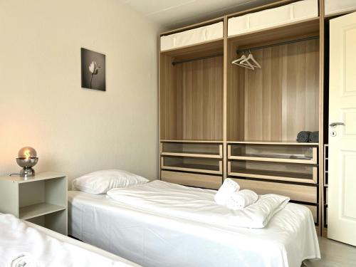 a bedroom with two beds and a closet at Spacious Apartment for 4 in Aalborg