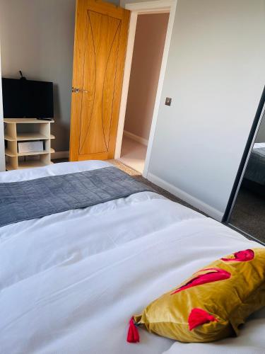 a bedroom with a large white bed and a television at Atlantic View - Sauna and Sunsets in Isle of Lewis