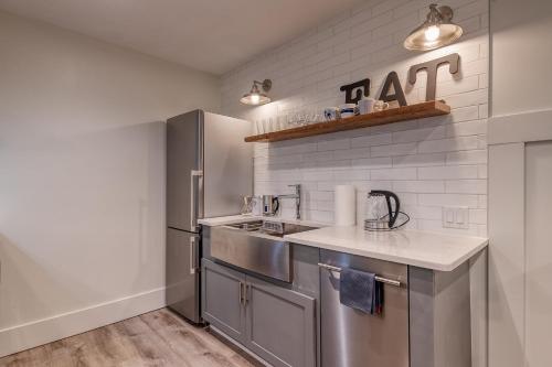 a kitchen with stainless steel appliances and white walls at The 4M Golden House - Central Location Beautiful Space & Neighborhood in Ann Arbor