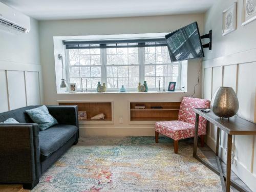 a living room with a couch and a window at The 4M Golden House - Central Location Beautiful Space & Neighborhood in Ann Arbor