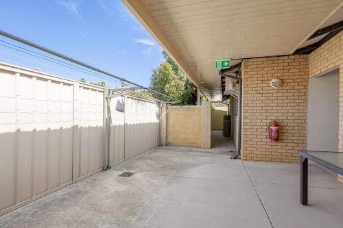 an empty parking lot next to a building at 9-3 Glenelg Place Connolly A9 Elegant 3 bed apt in the heart of Connolly in Perth