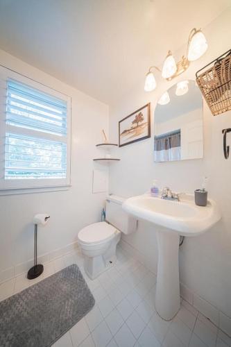 a white bathroom with a sink and a toilet at Springwells Park Townhouse Very Cozy in Dearborn