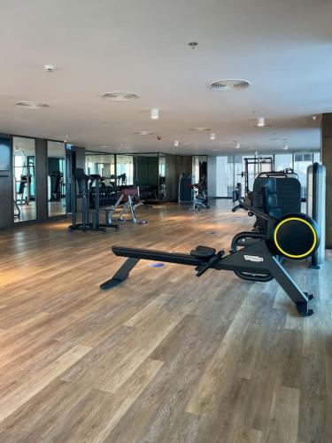 a room with a gym with a treadmill and exercise equipment at Blue Seaview 75 inch Smart TV 1Br in Manama
