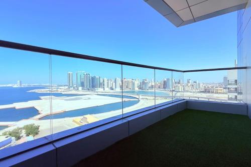 a large balcony with a view of the city at Blue Seaview 75 inch Smart TV 1Br in Manama