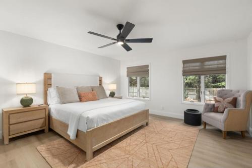 a bedroom with a bed with a ceiling fan and a chair at Spacious 3BR Yavapai Retreat with Nature Views, Hot Tub and Game Room in Sedona