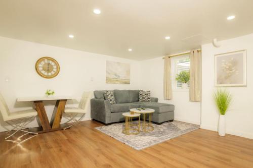 a living room with a couch and a table at The Minimalist Escape - Modern 1BD in the Heights in Peoria Heights
