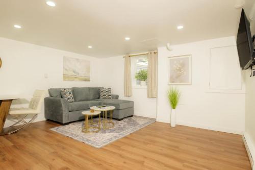 a living room with a couch and a table at The Minimalist Escape - Modern 1BD in the Heights in Peoria Heights