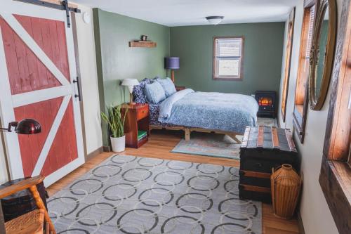 a bedroom with a bed and a barn door at Historic Farmhouse Apartment 