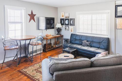a living room with a couch and a table at Historic Farmhouse Apartment 