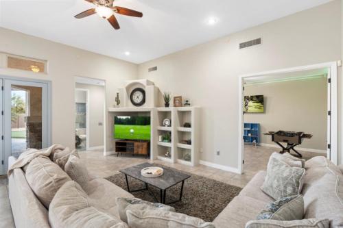 a living room with a couch and a tv at 4BR Mesa Mountainside Retreat with Pool, Hot Tub and Games in Mesa