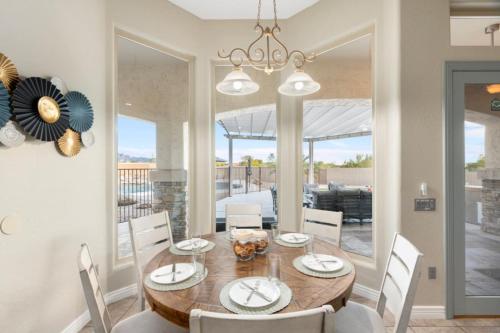 a dining room with a wooden table and chairs at 4BR Mesa Mountainside Retreat with Pool, Hot Tub and Games in Mesa