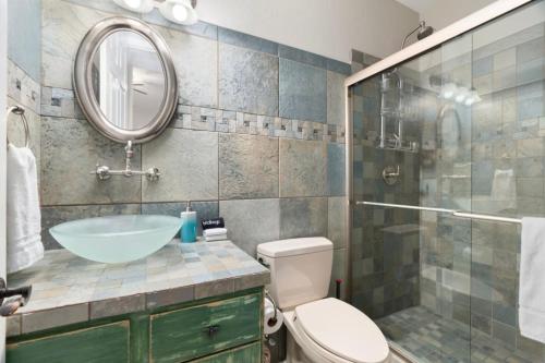 a bathroom with a sink and a toilet and a mirror at 4BR Mesa Mountainside Retreat with Pool, Hot Tub and Games in Mesa
