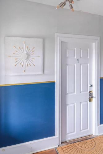 a door in a room with a blue and white wall at Cute Apartment in the Heart of Winooski in Winooski
