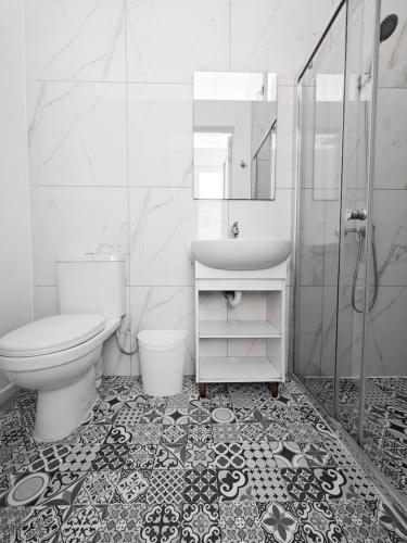 a bathroom with a toilet and a sink and a shower at Cosy Room 8 in Tal-Pietà