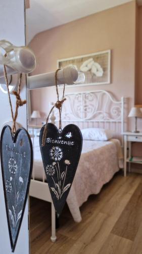 a bedroom with a bed with a heart sign on it at Foresteria Villa Simona in Colico