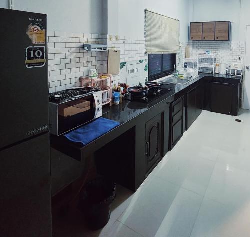 a kitchen with a stove top oven in a kitchen at Damiya Peaceful House in Ban Bo Dan