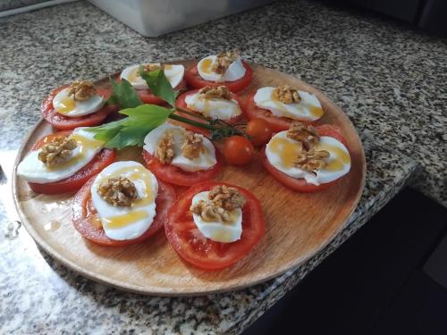 a plate of tomatoes with eggs and nuts on it at Golden Mirror in Lamego