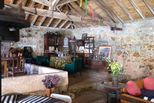 a room with a bar with a stone wall at Quinta Maria Gil - B in Lourinhã