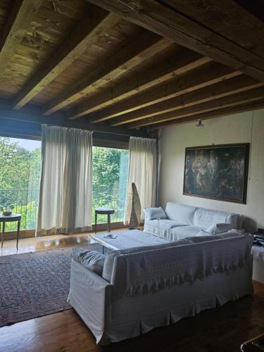 a living room with a large bed and a couch at B&B Il Posto delle Rose in Almenno San Salvatore